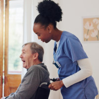 female caretaker guiding her man patient with wheelchair