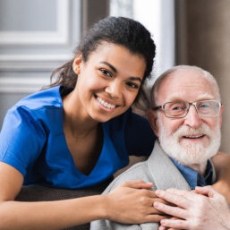 elderly couple hug and smile