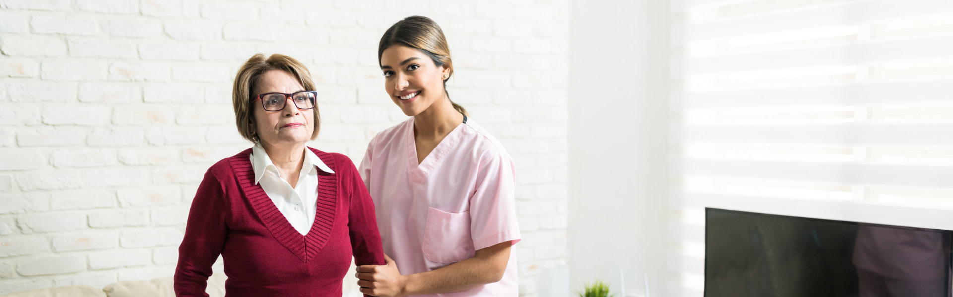 Nurse Supporting Senior Patient At Home